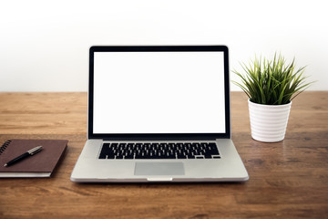 Blank empty white screen laptop computer on wooden table