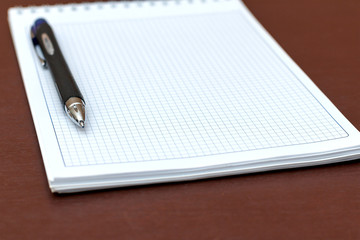The notebook in the box with pen closeup
