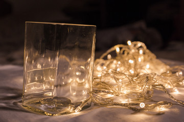 glass cup with LED light bulb wire in background