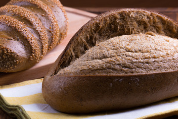 Jewish bread on brown wooden background and fabric napkin