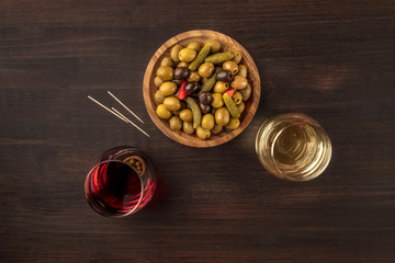 Overhead photo of pickled olives with wine and copy space