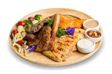Closeup grilled beef and salmon fish steak with sauces served in wood plate isolated on white background