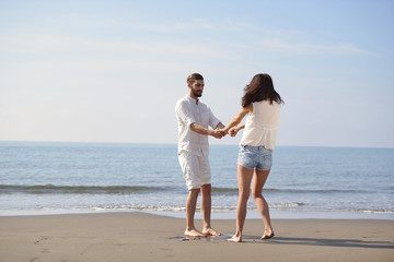 happy young romantic couple in love have fun on beautiful beach at beautiful summer day.