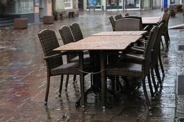 Fototapeta na wymiar Rainy Day / Table with chairs on the street