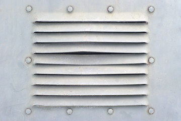 background in the military style: a section of a metal ight grey wall or shell of some armored...