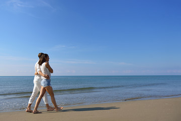 Beach couple walking on romantic travel honeymoon vacation summer holidays romance.