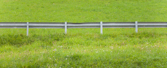 Fototapeta premium secondary road guardrail in a mountain pasture