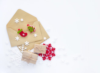 Christmas, happy new year composition. Christmas gifts, envelopes, christmas decorations, snowflakes on white background. Top view.