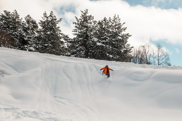 Snowboard rider descending down the snow slope