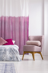 Pink armchair in girl's bedroom