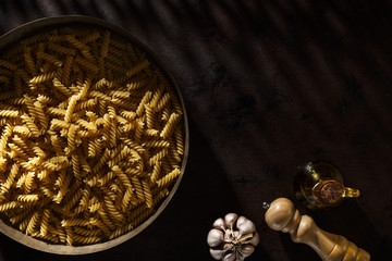 Fusilli Raw Pasta With Garlic, Pepper Mill And Olive Oil.