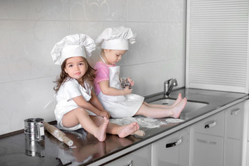 Funny kids are preparing the dough in the kitchen. happy family