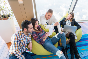 Multiethnic startup business team on meeting in modern bright office interior brainstorming, working on laptop