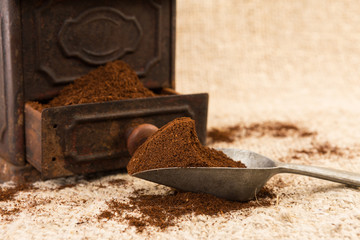 Ground coffee scoop and vintage grinder
