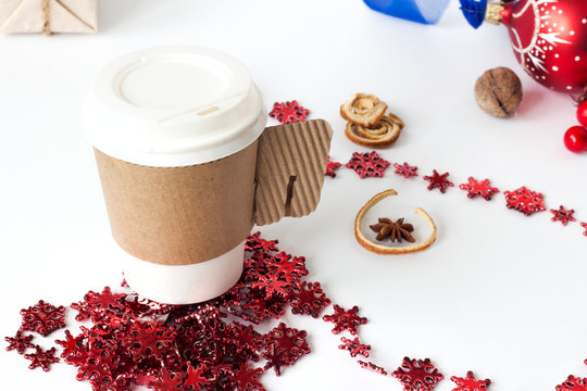 A paper cup of coffee, peppermint mocha, displayed with christmas decorations on white background