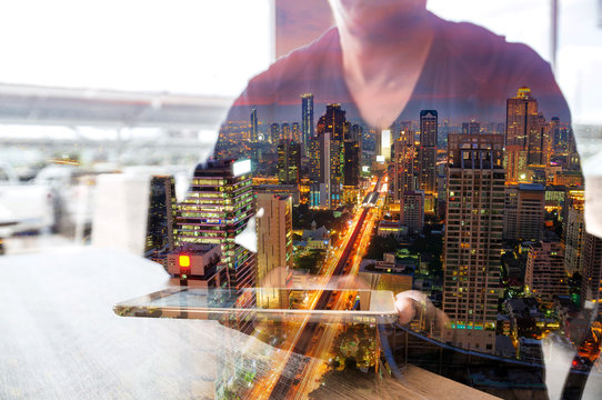 Double Exposure of Man or Male hold Digital Wireless Tablet with City Building