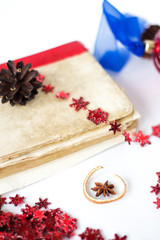 Christmas book anise and decorations on white table with copy space