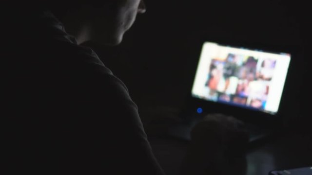 Man secretly watching porn sites at night.