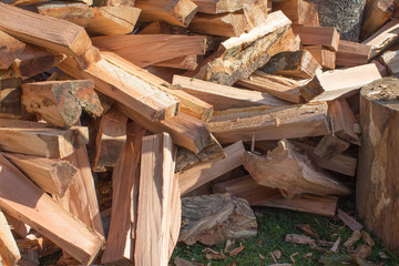 Natural wooden background, closeup of chopped firewood. Chopped firewood on a stack