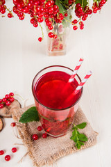 Morse from red currant (juice, compote) on a light background.