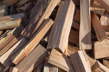 Natural wooden background, closeup of chopped firewood. Chopped firewood on a stack