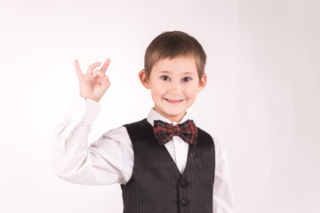 A boy posing in studio over grey background 
