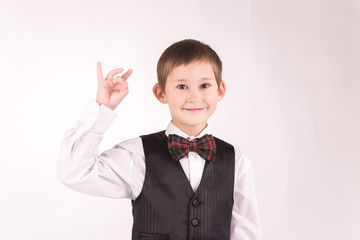 A boy posing in studio over grey background 