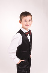 A boy posing in studio over grey background 