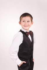 A boy posing in studio over grey background 
