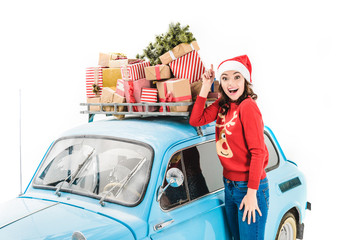 woman with christmas gifts on car roof
