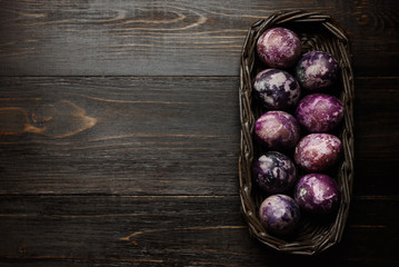 Expensive marble Easter eggs on a wooden background