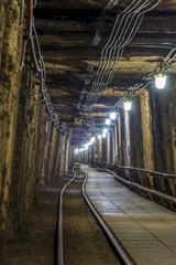 Illuminated underground tunnel in old mine