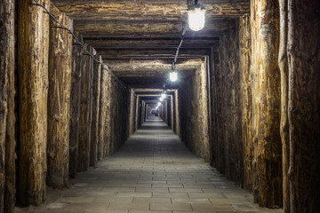 Fototapeta na wymiar Illuminated underground tunnel in old mine