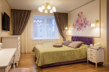 luxurious bedroom in purple and gold colors with window