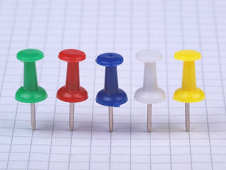 Multicolored buttons on white sheet of paper