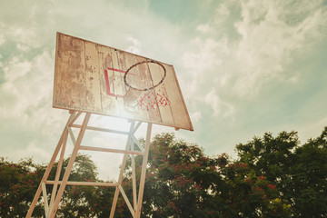 Basketball hoop and wood backboard at sunset (vintage style)