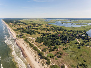 Aerial view over a Baltic Sea shore line in Pape, Latvia. During summer season.