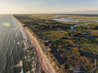 Aerial view over a Baltic Sea shore line in Pape, Latvia. During summer season.