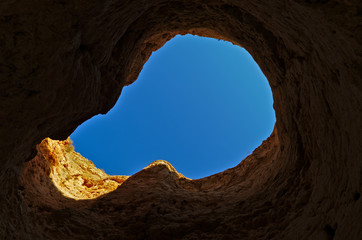 Looking to the sky through a cliff hole