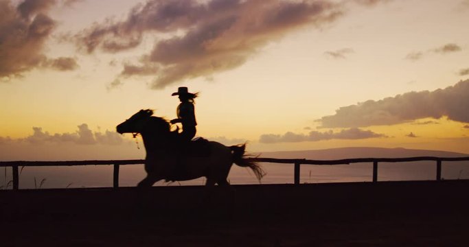 Silhouette of Woman horseback riding at sunset