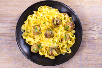 Egg noodles with beef meatballs. overhead, horizontal