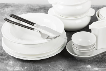Clean white tableware on a gray background