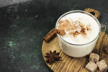Christmas drink eggnog and ingredients on a green background. Copy space