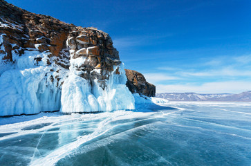 Baikal Lake. The sun, the blue sky, beautiful icy rocks and endless ice expanses. March is the best time to travel on a frozen lake