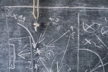 whistle of a soccer coach / referee on black board with strategy drawing