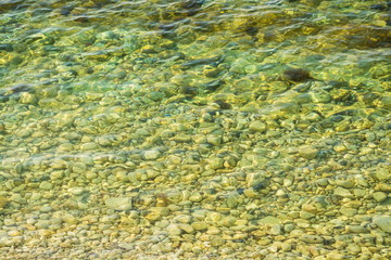Sea stones under transparent water at the bottom of the sea