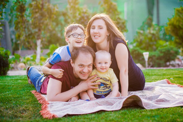 Naklejka na ściany i meble A happy family with two children outdoors