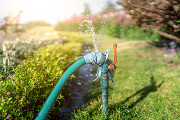 Wasting water - water leaking from a hole in a hose