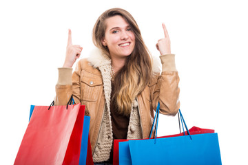 Shopper girl pointing at copy space