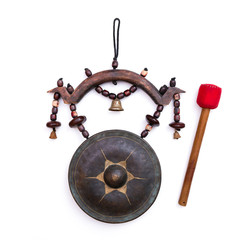 Medieval Asian gong. 
Closeup of an old Asian gong with a wooden mallet on white background